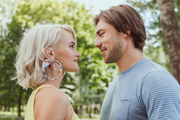 Obraz premium side view of couple looking at each other in park