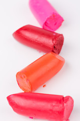 Lipstick slices collection. Close up of four slices lipstick on white background