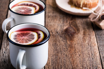 Cozy hot winter drink with lemon slices