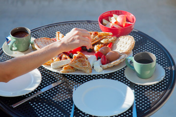 Traditional Crete food on breakfast, potatoes, cheese feta and bread with coffee or tea. Outdoor