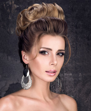 Beautiful evening hairstyle. Portrait of young woman with professional makeup and clean skin