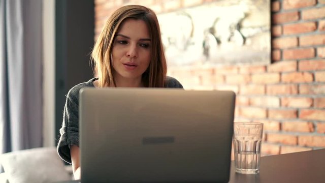Young businesswoman finish working on laptop and relaxing at home
