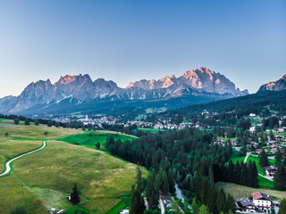 Panorama Cortina D Ampezzo Valley South Tyrol ,Italy, Europe. Panoramic view with alpine green landscape and massive Dolomites Alps in the background.  Panoramic view. Storm rain over rock mountain