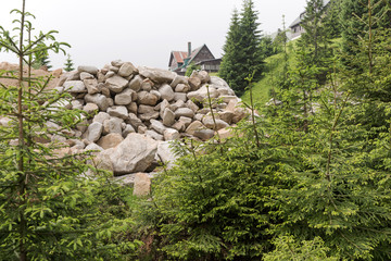 Building rubble from large stones lie in the forest
