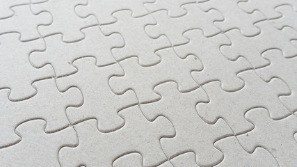 Hand put missing jigsaw puzzle into the paper board