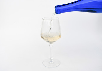 Glass with white wine filling on white background