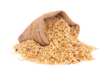 pounded unripe rice in jute sack isolated on white background