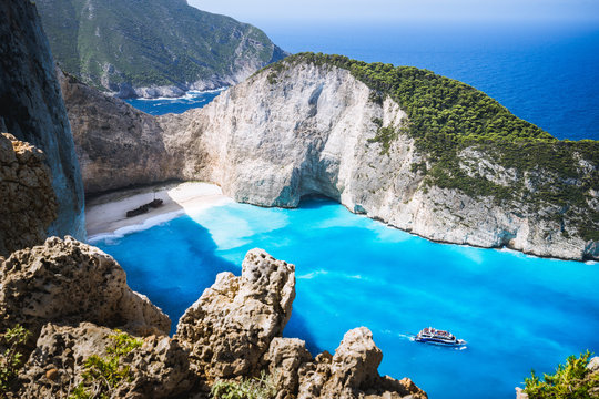 Navagio beach or Shipwreck bay with turquoise water and pebble white beach. Famous landmark location. Landscape of Zakynthos island, Greece