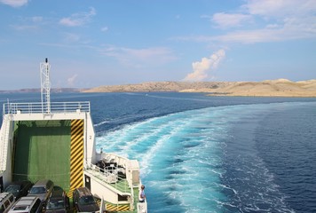 Obraz na płótnie Canvas On a car ferry in Croatia. View of the island Rab, on the route between Stinica and Misnjak. On this side the island is rocky with sparse vegetation. South Europe.