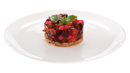 Salad Vinaigrette served on a slice of rye bread, decorated with fresh Basil. Isolated on white background.