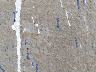 Paint running on the plaster. Stone wall. Texture. Background.