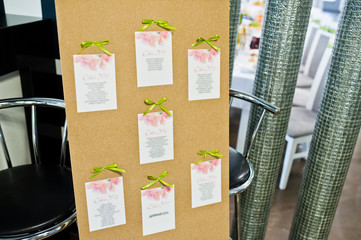 Wedding guest board with green ribbons in the restaurant.