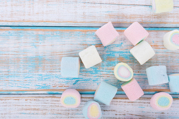 marshmallows on wooden background. top view