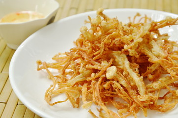fried needle mushroom on plate dipping sweet sauce