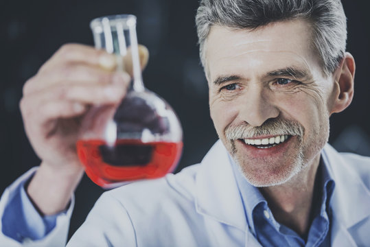 Happy Professor Look at Vial with Chemical Liquid.