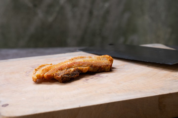 Crispy Pork Belly on wooden chopping board