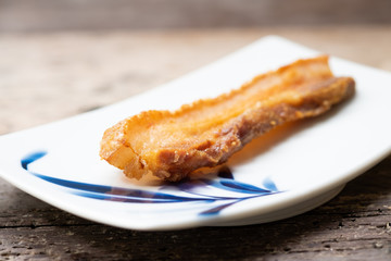 Crispy Pork Belly on wooden chopping board