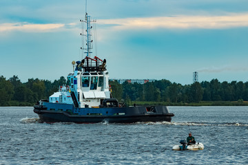Black tug ship underway