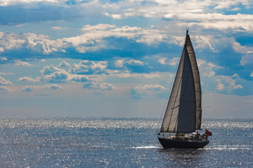 Fototapeta na wymiar Blue sailboat at journey