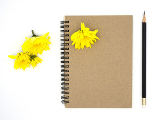 top view book  and pencil for note isolated on white background decorate by chrysanthemum, yellow. Desk office concept with copy space,book and pencil, diary