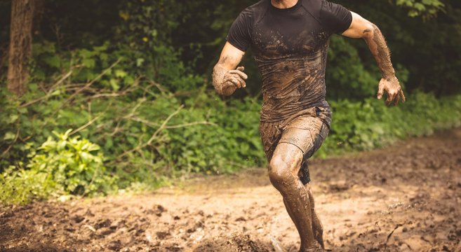 Fit man training over obstacle course