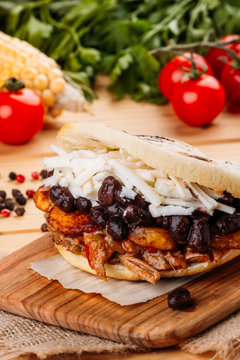 The typical Venezuelan Arepa called Pabellon, which has seasoned minced meat, fried plantain, black beans and white cheese