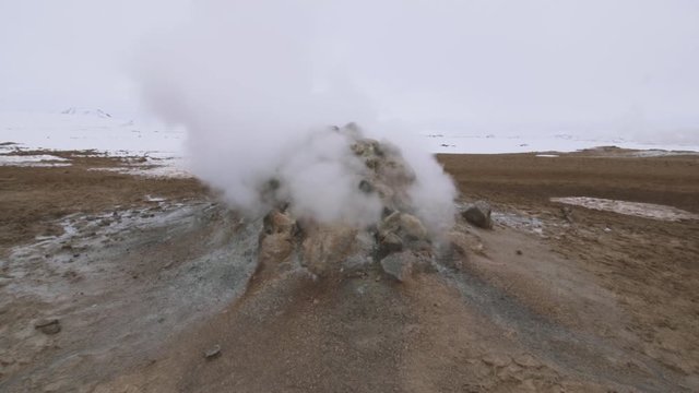 Myvatn, Iceland thermal vent. Steam and sulfer spray out from fields of boiling mud.