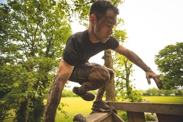  Fit man training over obstacle course