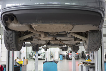 Car in garage, auto repair service shop with special repairing equipment