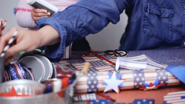 Step by step. Mother and daughter making paper lantern for July 4th celebration