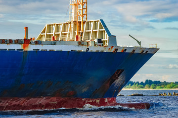 Blue cargo ship underway