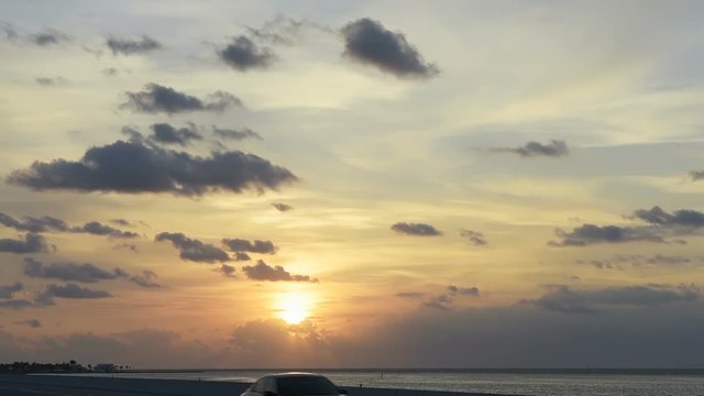 Sunrise in Florida Keys, Islamorada village of islands, with pink blue sky, overseas highway road, in Atlantic Ocean, gulf of Mexico, horizon, cars in slow motion