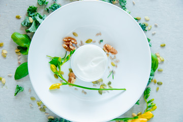Cream with herbs and walnut on a talbe