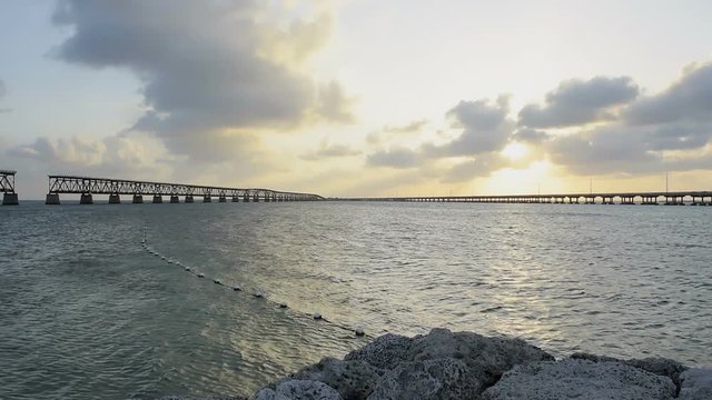 Sunset dark evening in Bahia Honda State Park, Florida Keys, with old rail and seven mile bridge, ocean and gulf of mexico, slow motion