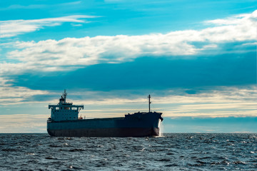 Obraz premium Blue cargo ship underway