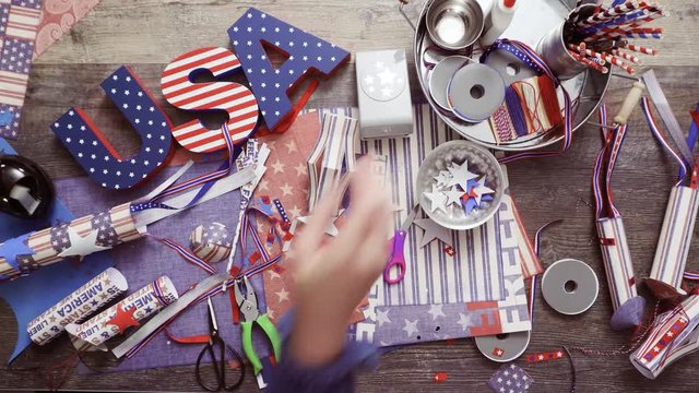 Step by step. Mother and daughter making paper lantern for July 4th celebration
