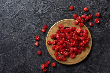Dried red cherries on a plate. Top view.