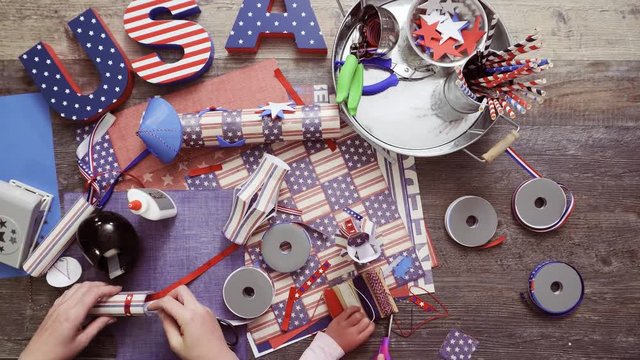 Step by step. Mother and daughter making paper lantern for July 4th celebration