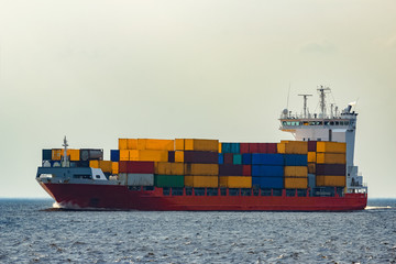 Red container ship underway