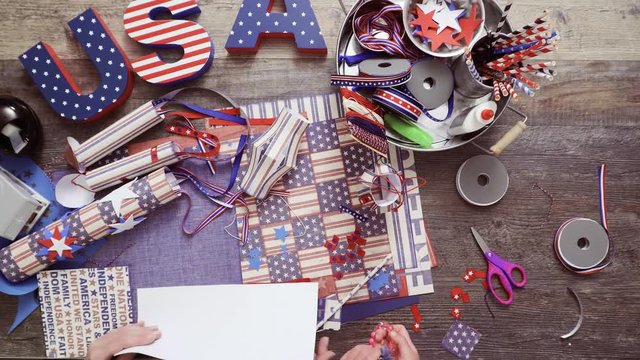 Step by step. Mother and daughter making paper lantern for July 4th celebration