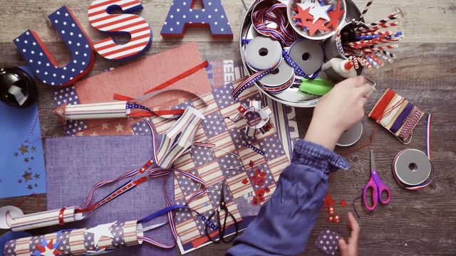 Step by step. Mother and daughter making paper lantern for July 4th celebration