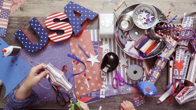 Step by step. Mother and daughter making paper lantern for July 4th celebration