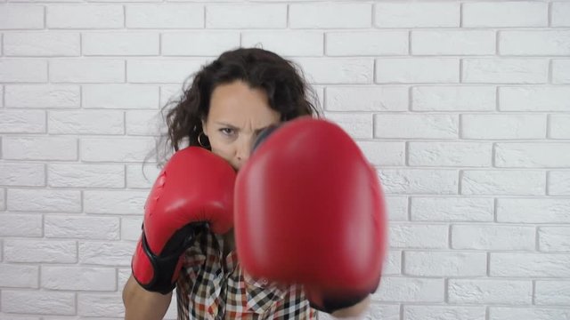 Emancipation. Woman in boxing gloves. A woman in boxing gloves is boxing.