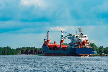 Blue cargo ship underway