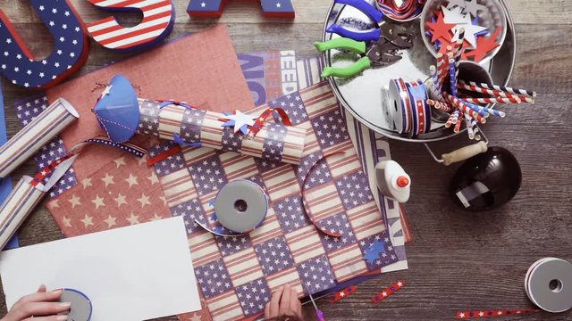 Step by step. Mother and daughter making paper lantern for July 4th celebration