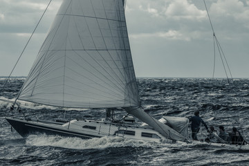 Blue sailboat at storm