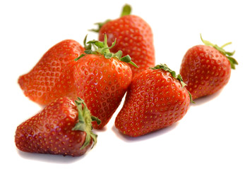 Pile of fresh strawberries isolated on white background