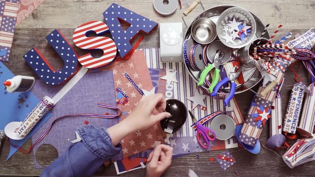 Step by step. Mother and daughter making paper firecrackers for July 4th celebration