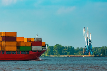 Red container ship underway