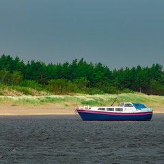 Obraz premium Small blue passenger ship